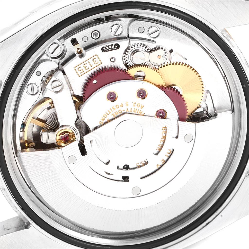 The image shows the internal movement of a Rolex Datejust 116233 Men's Stainless Steel Mother of Pearl Dial 116233 Men's Stainless Steel Mother of Pearl Dial watch, highlighting gears, springs, and the rotor.