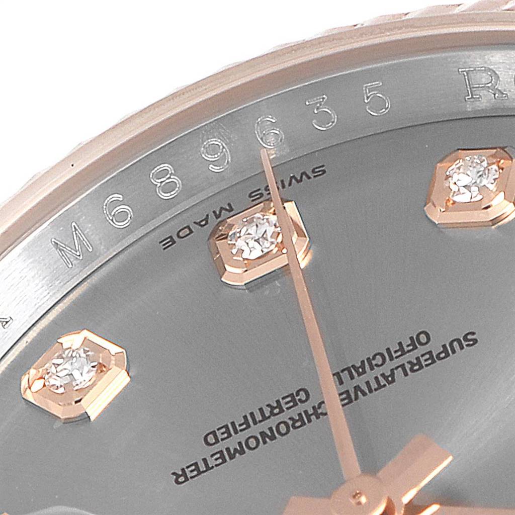 A close-up of the Rolex Datejust 116231 Men's Steel and Gold (two tone) Grey Dial 116231 Men's Steel and Gold (two tone) Grey Dial watch shows diamond markers, the sweeping second hand, and part of the serial number on the outer rim.