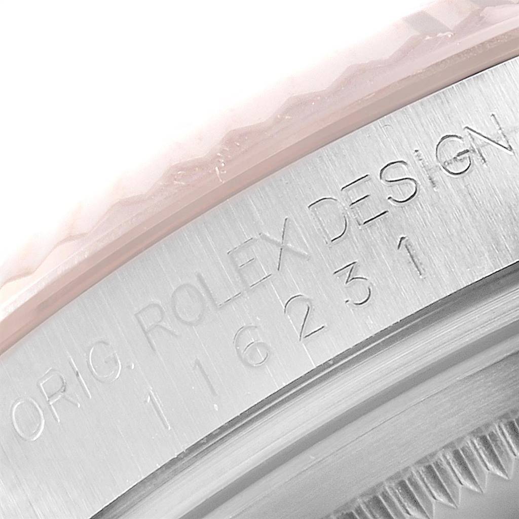 This image shows a close-up of the engraved bezel of a Rolex Datejust 116231 Men's Steel and Gold (two tone) Blue Dial 116231 Men's Steel and Gold (two tone) Blue Dial watch.