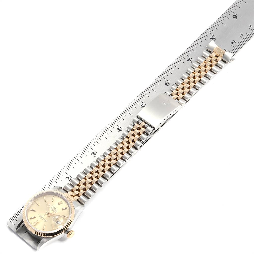 The image shows a Rolex Datejust 16233 Men's Steel and Gold (two tone) Champagne Dial 16233 Men's Steel and Gold (two tone) Champagne Dial watch laid flat with its bracelet alongside a ruler, viewed from above.