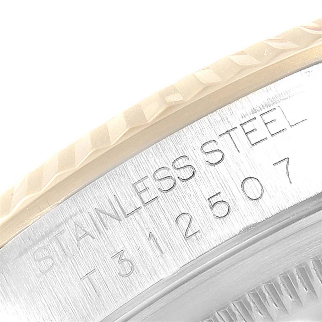 The image shows a close-up of the stainless steel case and bezel of a Rolex Datejust 16233 Men's Steel and Gold (two tone) Champagne Dial 16233 Men's Steel and Gold (two tone) Champagne Dial watch, featuring its engraved serial number.