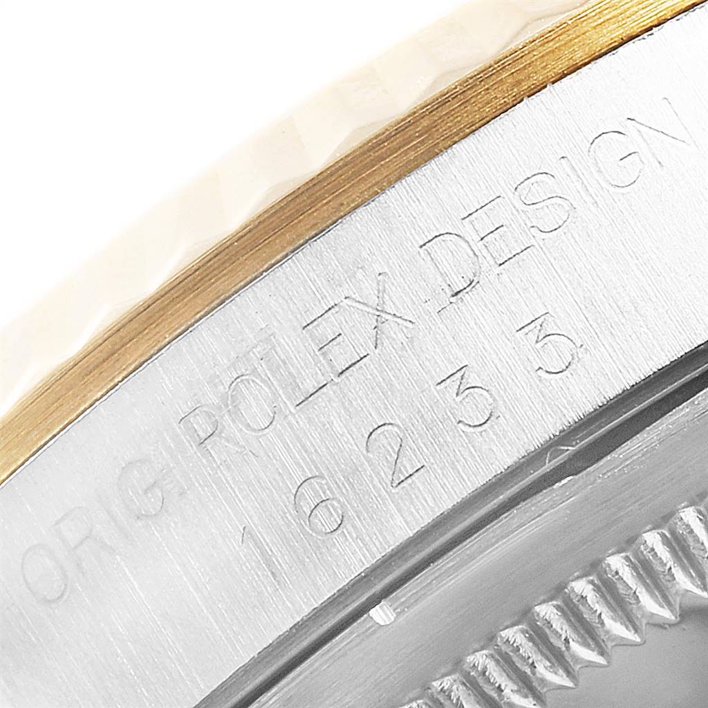 This image shows a close-up of the side of a Rolex Datejust 16233 Men's Steel and Gold (two tone) Champagne Dial 16233 Men's Steel and Gold (two tone) Champagne Dial watch, displaying the model number and engravings.