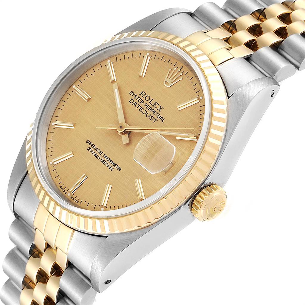 The image shows a close-up angle of the Rolex Datejust 16233 Men's Steel and Gold (two tone) Champagne Dial 16233 Men's Steel and Gold (two tone) Champagne Dial watch, highlighting the gold dial, fluted bezel, and jubilee bracelet.