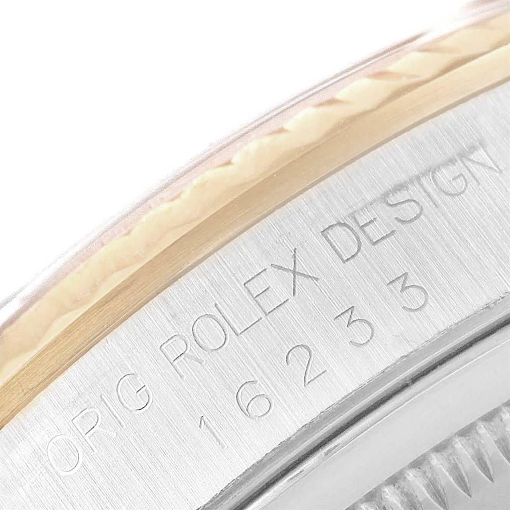 This close-up image shows the side engraving of a Rolex Datejust 16233 Men
s Steel and Gold (two tone) Beige Dial 16233 Men
s Steel and Gold (two tone) Beige Dial watch, displaying the model number and "ROLEX DESIGN."