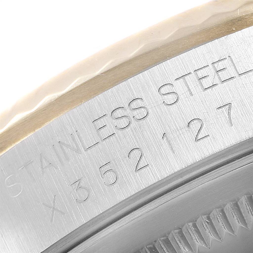 The image shows a close-up of the engraved stainless steel case back of a Rolex Datejust 16233 Men
s Steel and Gold (two tone) Champagne Dial 16233 Men
s Steel and Gold (two tone) Champagne Dial watch.