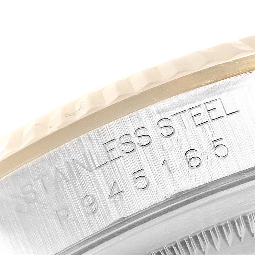 This close-up image shows the side engraving on the bezel of a Rolex Datejust 16233 Men's Steel and Gold (two tone) Champagne Dial 16233 Men's Steel and Gold (two tone) Champagne Dial watch, indicating it is made of stainless steel.