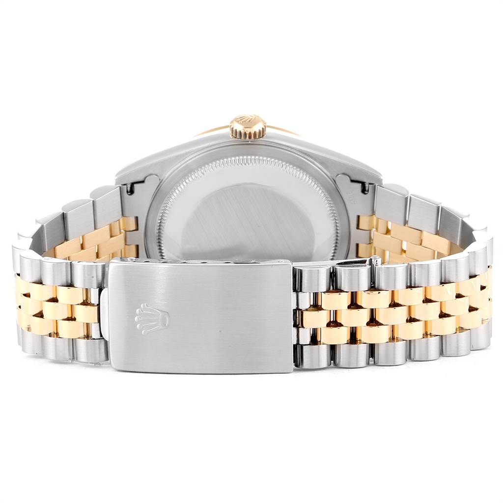 The image shows the backside and clasp of the two-tone bracelet of a Rolex Datejust 16233 Men's Steel and Gold (two tone) Champagne Dial 16233 Men's Steel and Gold (two tone) Champagne Dial watch.