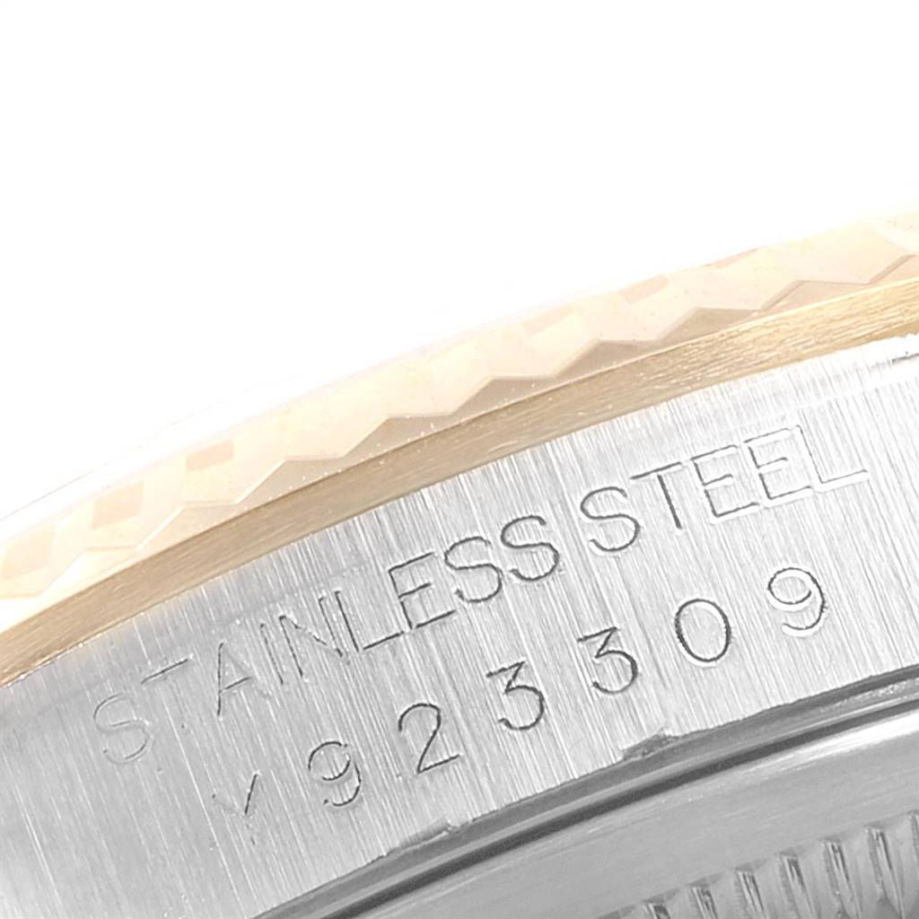 This close-up image shows the engraved case back and part of the bezel of a Rolex Datejust 16233 Men's Steel and Gold (two tone) Mother of Pearl Dial 16233 Men's Steel and Gold (two tone) Mother of Pearl Dial.