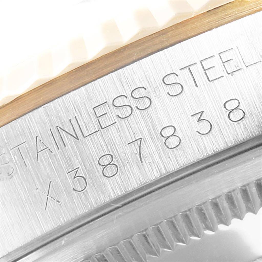 This close-up image shows the engraved stainless steel reference and serial number on the side of a Rolex Datejust 16233 Men's Steel and Gold (two tone) Champagne Dial 16233 Men's Steel and Gold (two tone) Champagne Dial watch case.