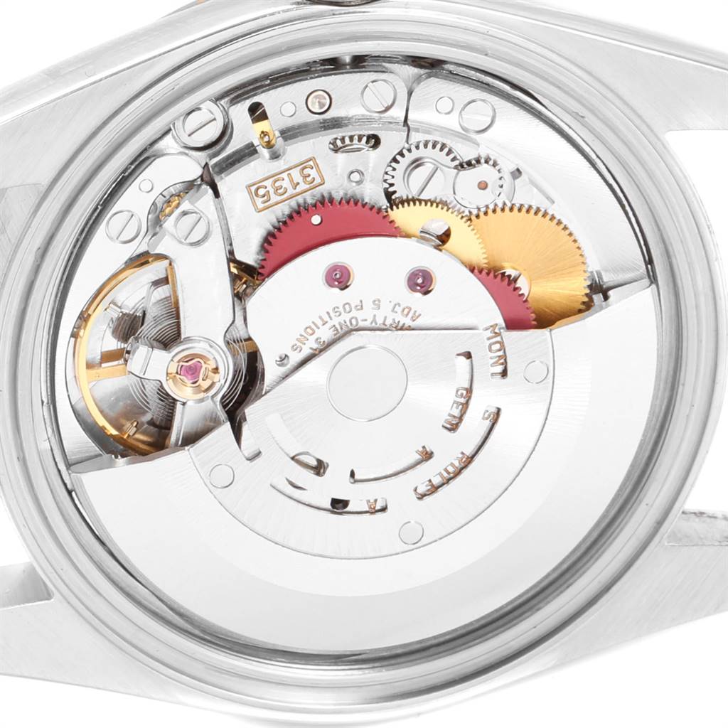This image shows the inner mechanism of the Rolex Datejust 16233 Men's Steel and Gold (two tone) Champagne Dial 16233 Men's Steel and Gold (two tone) Champagne Dial watch from a rear angle, revealing its intricate gears and components.
