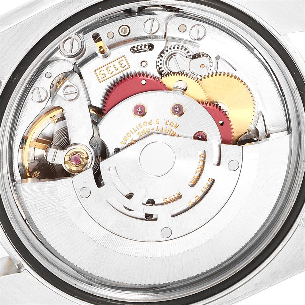 This image shows an internal view of the Rolex Datejust 116203 Men's Stainless Steel White Dial 116203 Men's Stainless Steel White Dial watch, highlighting its intricate mechanical movement and gears.