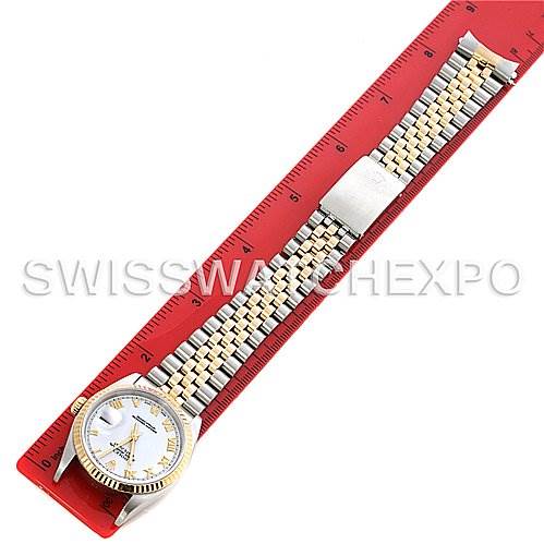 The image shows a Rolex Datejust 16233 Men's Steel and Gold (two tone) White Dial 16233 Men's Steel and Gold (two tone) White Dial model watch laid flat next to a red ruler, highlighting the dial, bracelet, and clasp.