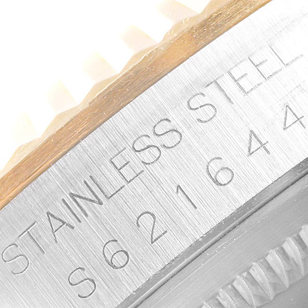 The image shows a close-up of the side of a Rolex Datejust 16233 Men
s Steel and Gold (two tone) Black Dial 16233 Men
s Steel and Gold (two tone) Black Dial watch, highlighting the stainless steel marking and part of the bezel.