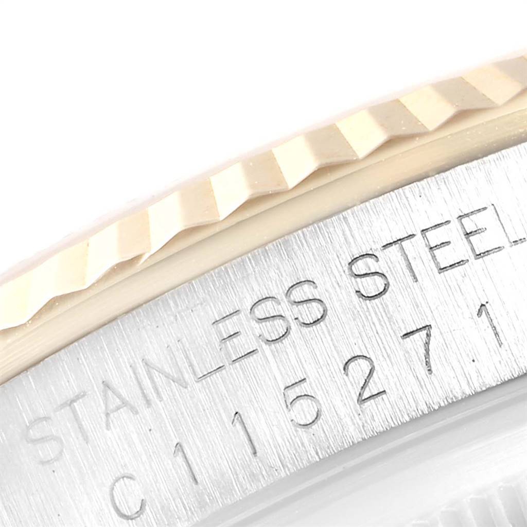 The image shows a close-up of the bezel and stainless steel case with etched text on a Rolex Datejust 16233 Men's Steel and Gold (two tone) Champagne Dial 16233 Men's Steel and Gold (two tone) Champagne Dial model.