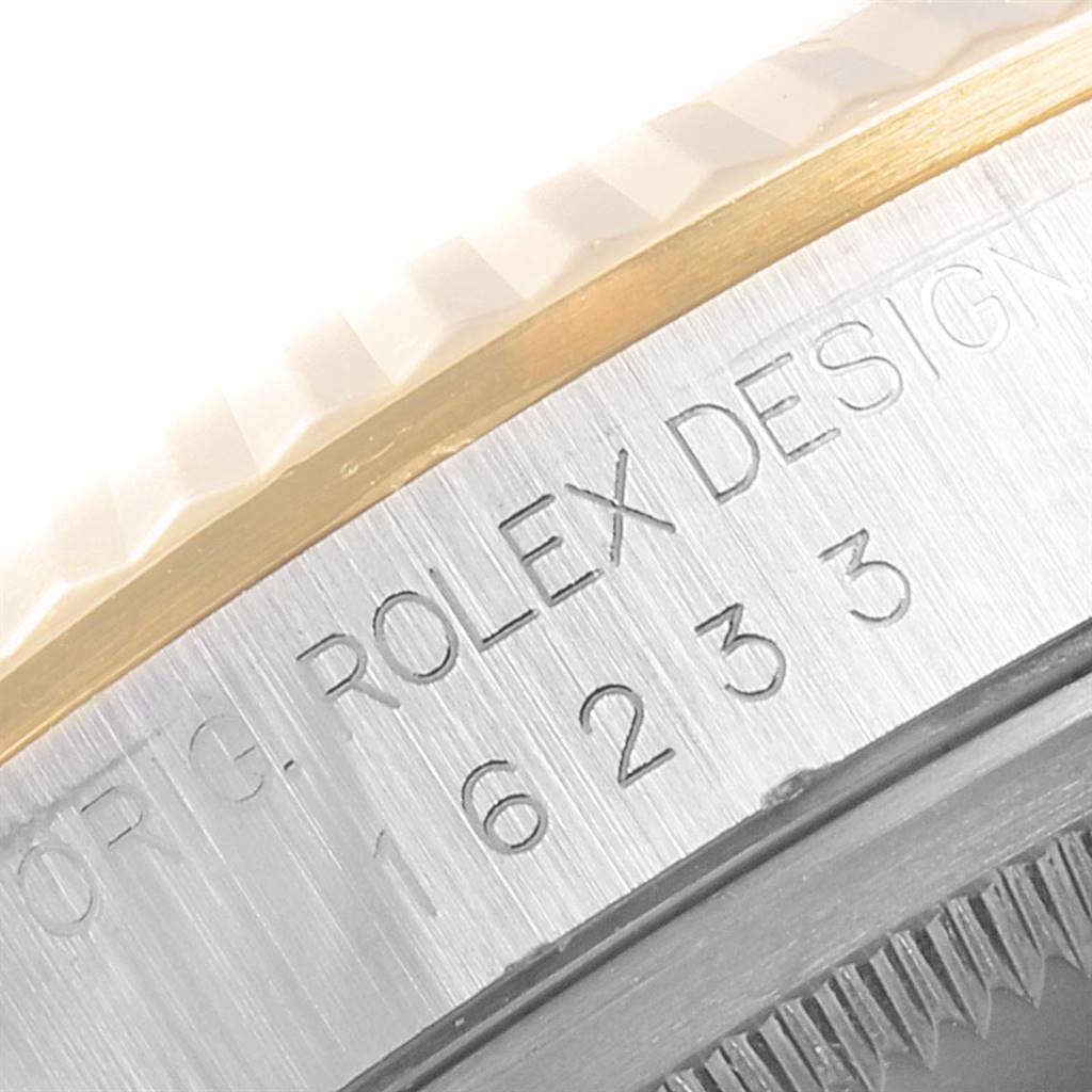 The image shows a close-up angle of the casing side and the fluted bezel of a Rolex Datejust 16233 Men
s Steel and Gold (two tone) Blue Dial 16233 Men
s Steel and Gold (two tone) Blue Dial watch, displaying the model number and design engraving.