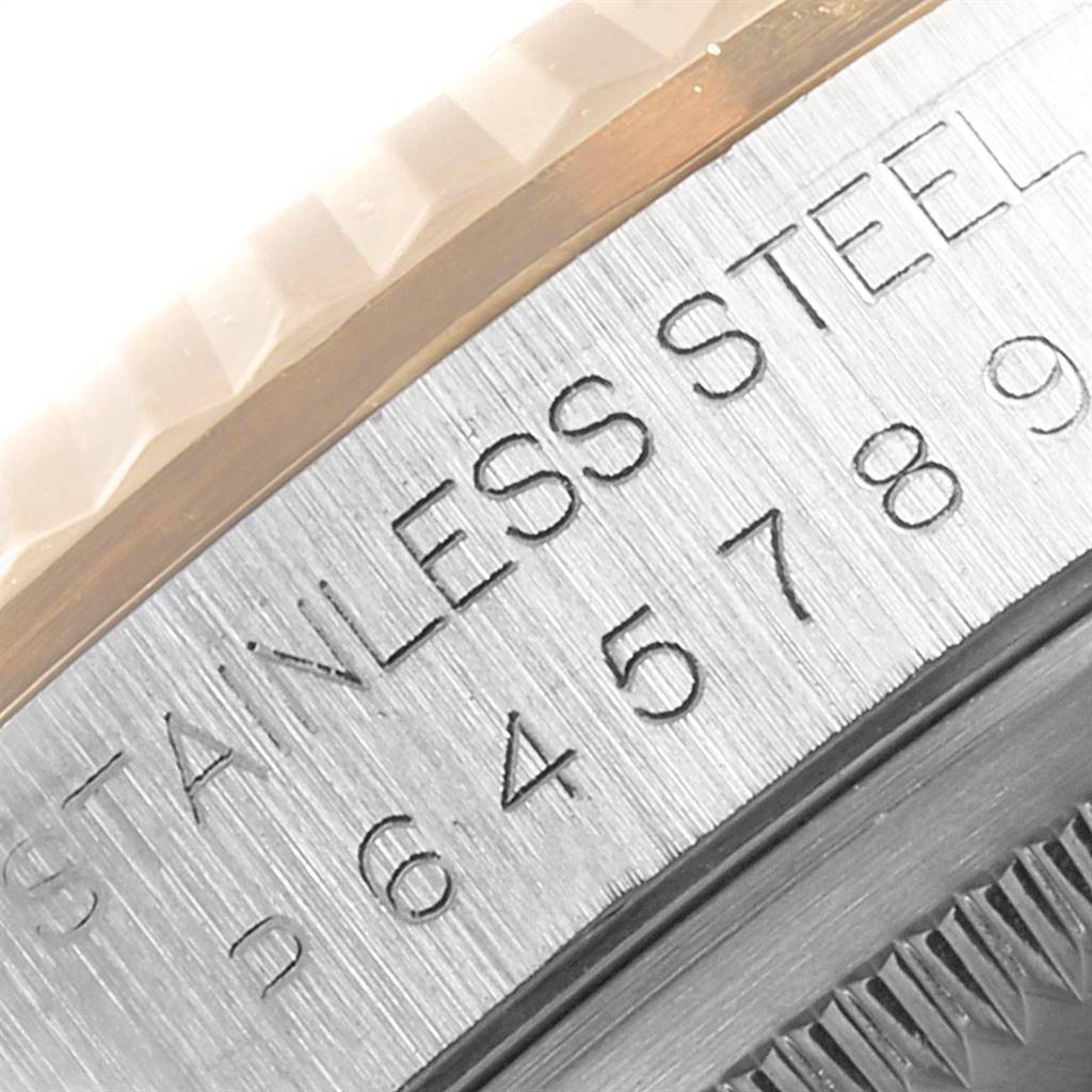 This close-up image of the Rolex Datejust 16233 Men
s Steel and Gold (two tone) Blue Dial 16233 Men
s Steel and Gold (two tone) Blue Dial watch shows part of the bezel and the engraved "STAINLESS STEEL" text.