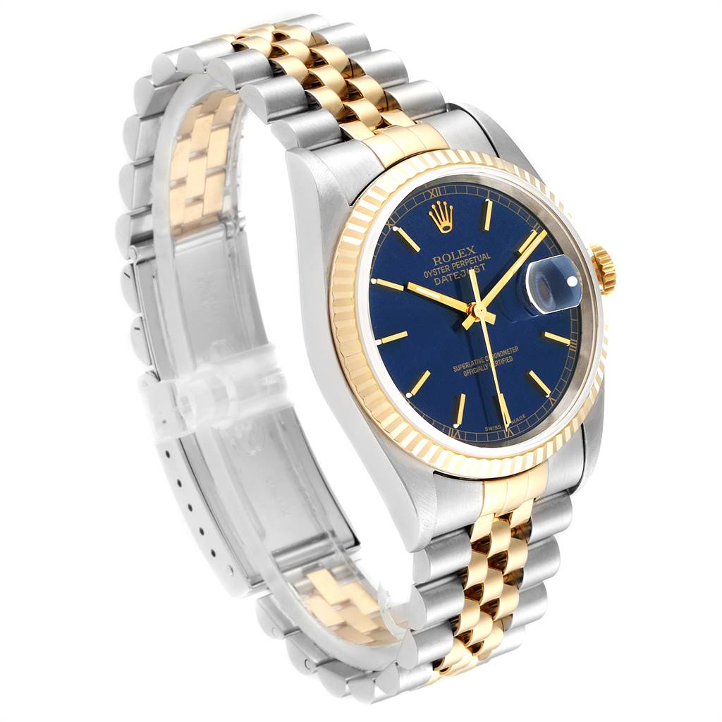 The Rolex Datejust 16233 Men
s Steel and Gold (two tone) Blue Dial 16233 Men
s Steel and Gold (two tone) Blue Dial watch is shown at a three-quarter angle, displaying the blue dial, bezel, crown, and two-tone bracelet.