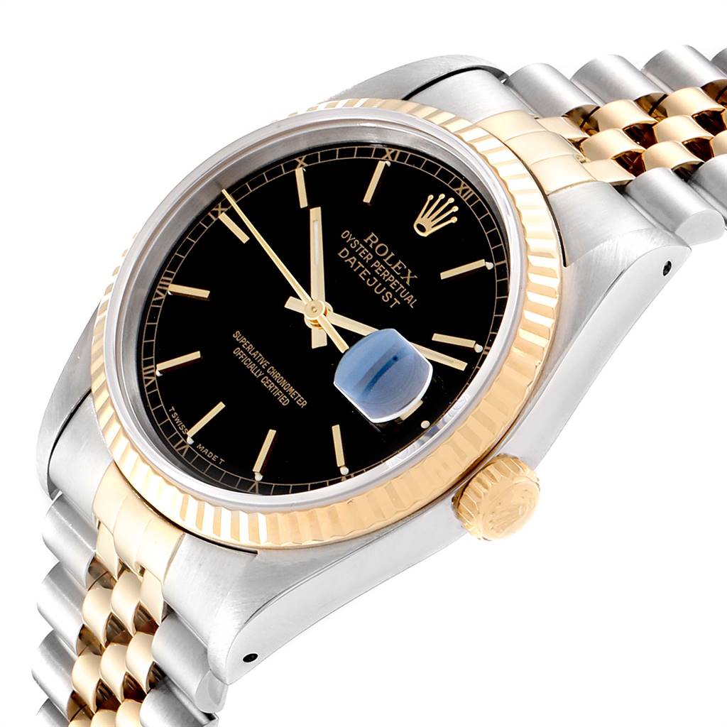 The image shows a close-up, angled view of a Rolex Datejust 16233 Men
s Steel and Gold (two tone) Black Dial 16233 Men
s Steel and Gold (two tone) Black Dial watch, highlighting its black dial, gold bezel, and two-tone bracelet.
