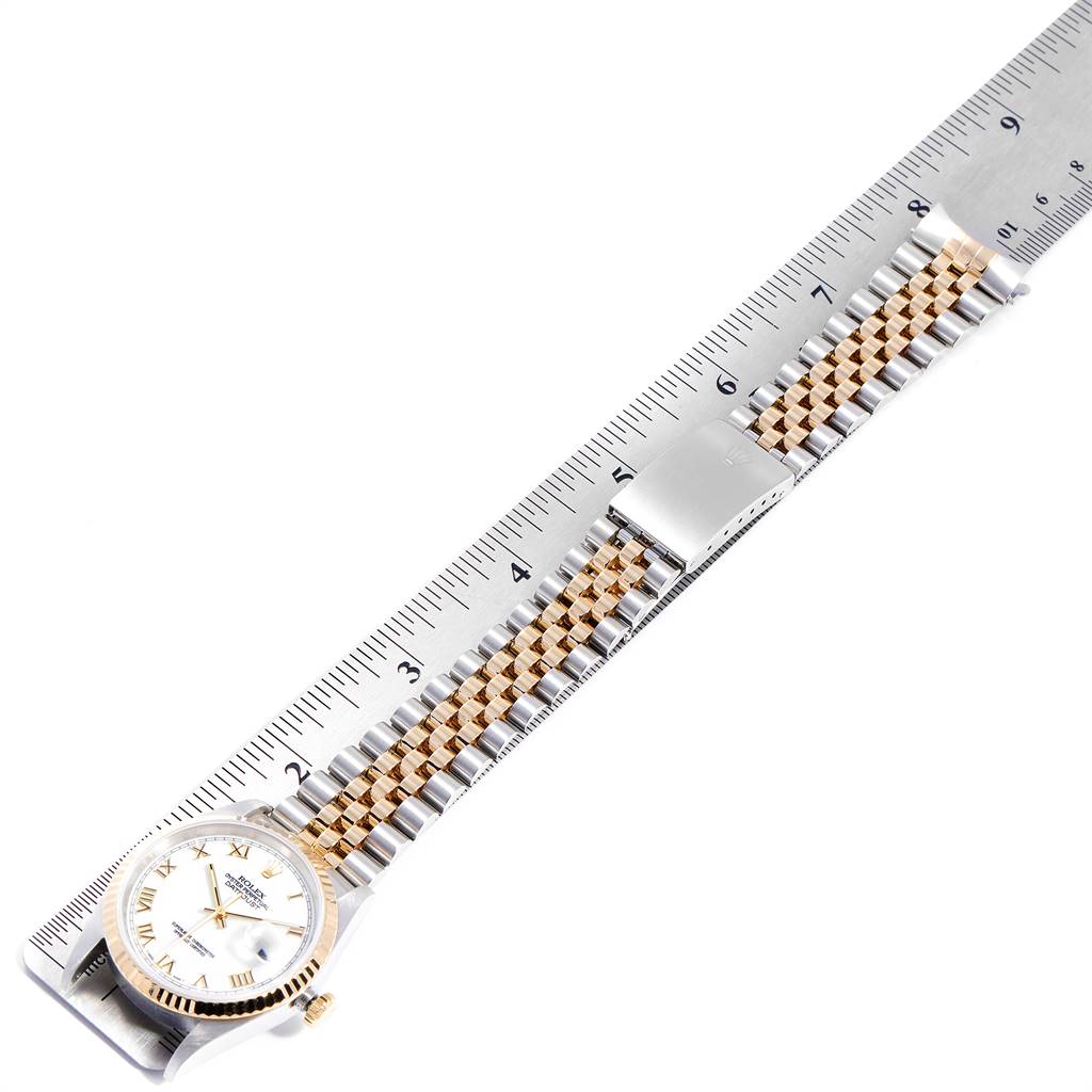 The image shows a Rolex Datejust 16233 Men's Steel and Gold (two tone) White Dial 16233 Men's Steel and Gold (two tone) White Dial watch positioned diagonally on a ruler, displaying the face and full bracelet.