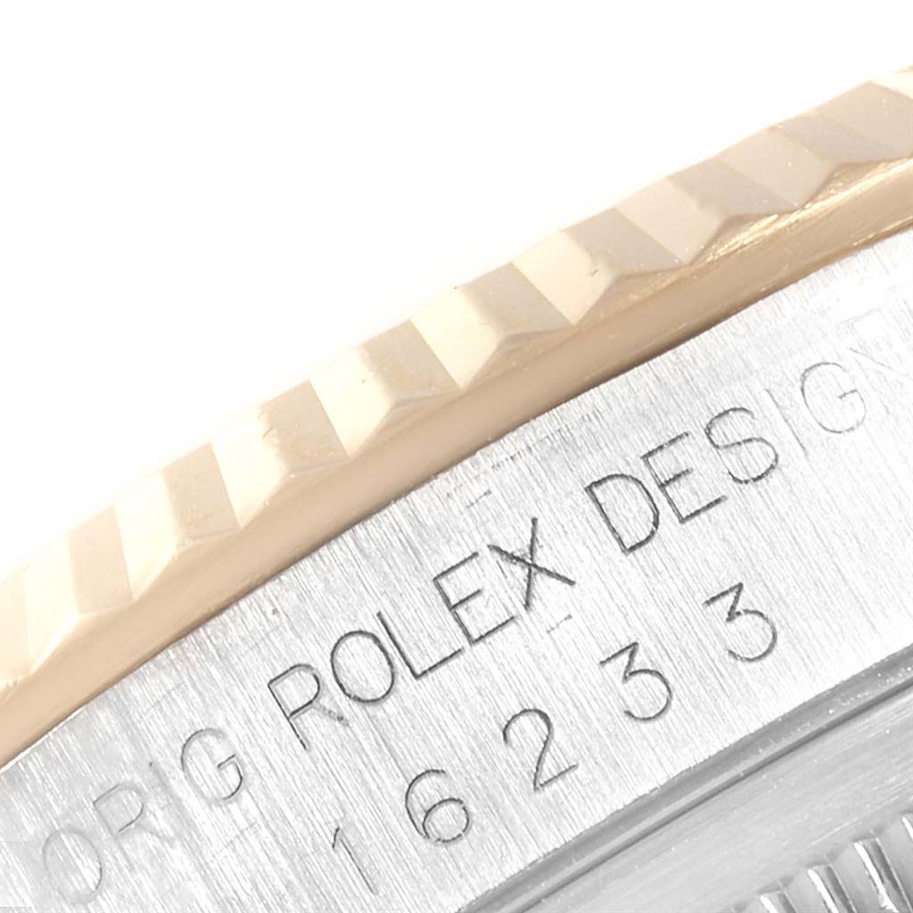 This image shows a close-up of the engraved bezel and case side of a Rolex Datejust 16233 Men's Steel and Gold (two tone) White Dial 16233 Men's Steel and Gold (two tone) White Dial.