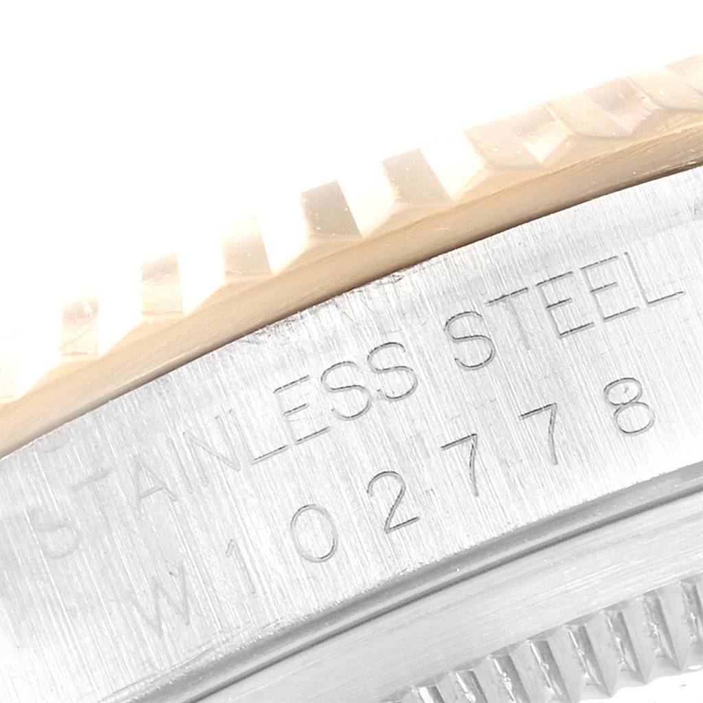 This close-up image shows the side of the bezel and part of the case of a Rolex Datejust 16233 Men's Steel and Gold (two tone) White Dial 16233 Men's Steel and Gold (two tone) White Dial model, made of stainless steel.