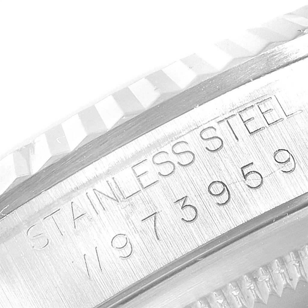 This close-up image shows the engraved stainless steel inner bezel and part of the fluted bezel edge of a Rolex Datejust 16234 Men's Stainless Steel Silver Dial 16234 Men's Stainless Steel Silver Dial watch.