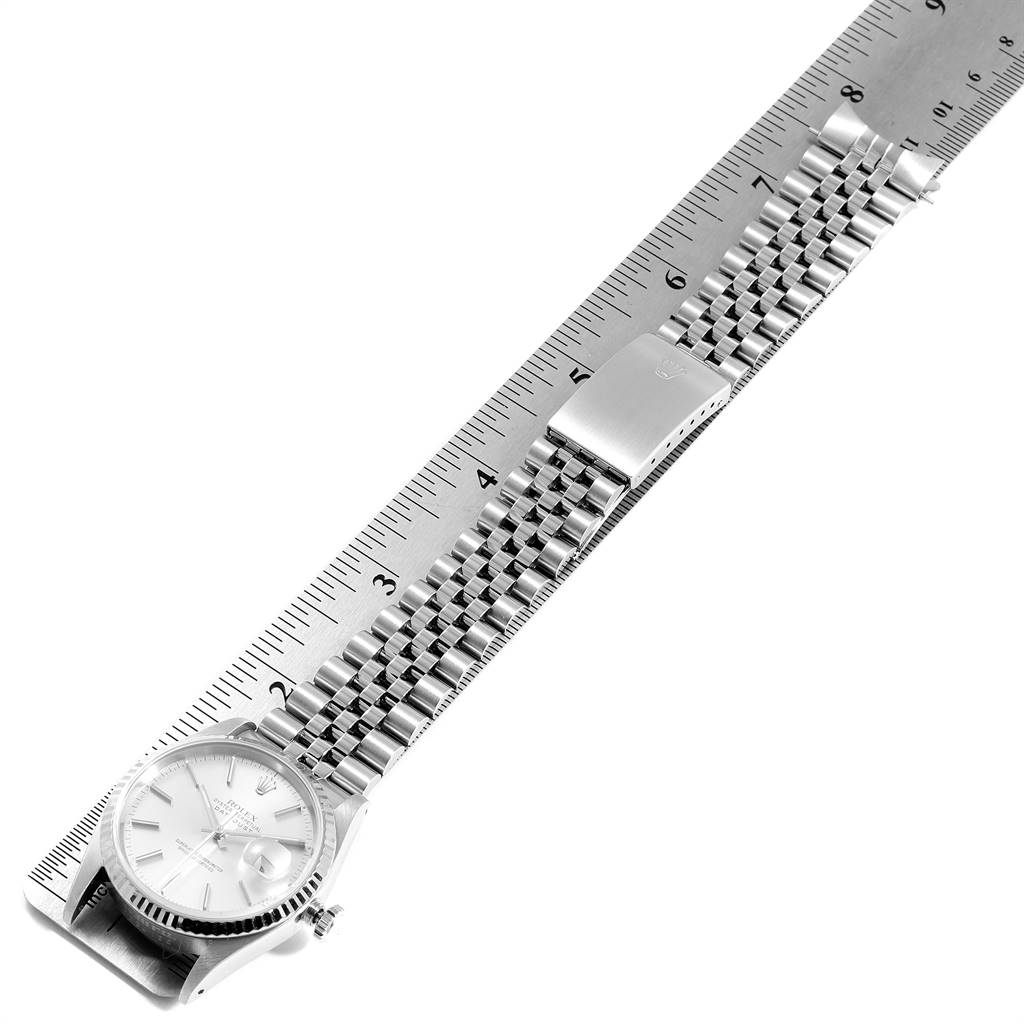 The image shows a Rolex Datejust 16234 Men's Stainless Steel Silver Dial 16234 Men's Stainless Steel Silver Dial watch laid flat with its bracelet extended, alongside a ruler for scale.