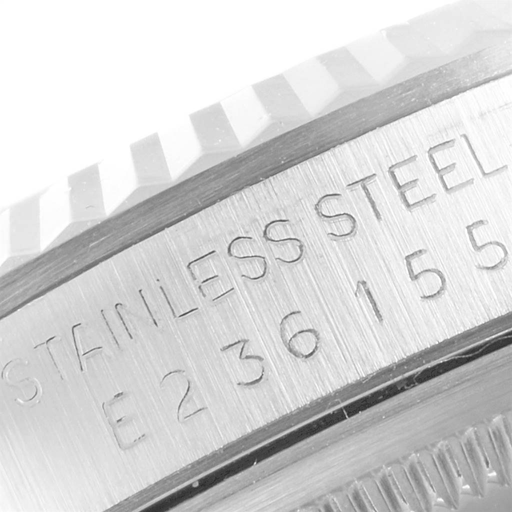 This close-up image of a Rolex Datejust 16234 Men's Stainless Steel Silver Dial 16234 Men's Stainless Steel Silver Dial watch shows the engraved stainless steel case and part of the fluted bezel.