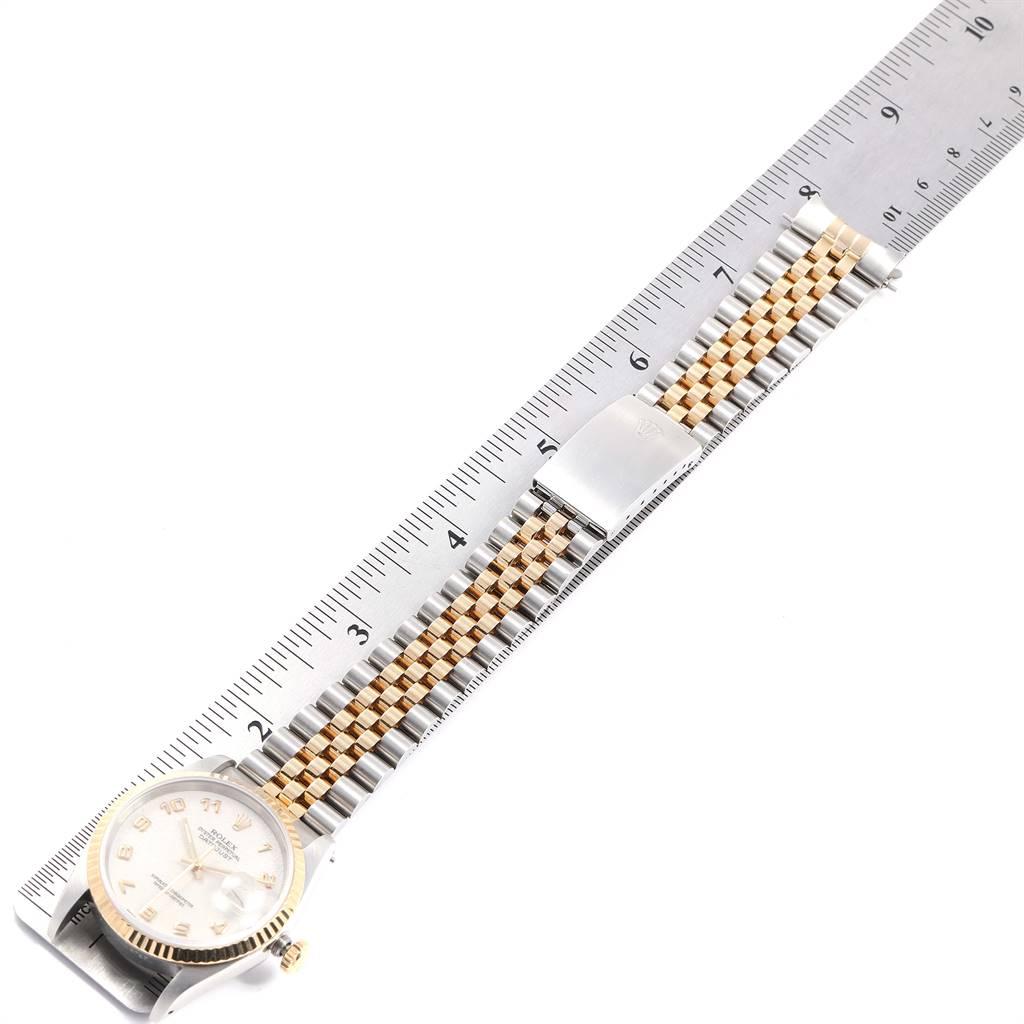This image shows a Rolex Datejust 16233 Men
s Steel and Gold (two tone) Beige Dial 16233 Men
s Steel and Gold (two tone) Beige Dial watch placed next to a ruler, displaying the face and the full length of the Jubilee bracelet.