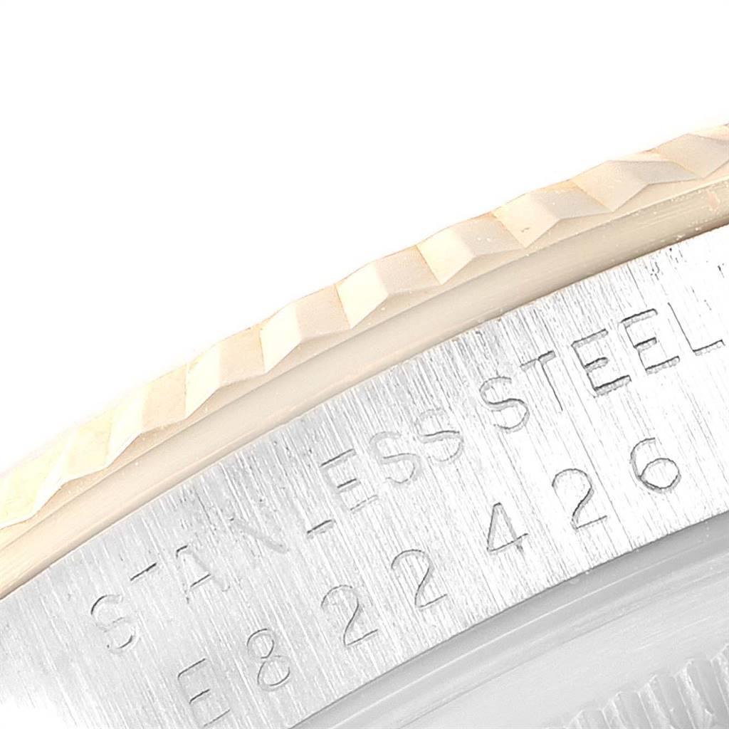 The image shows a close-up of the bezel and part of the engraved case back of a Rolex Datejust 16233 Men
s Steel and Gold (two tone) Beige Dial 16233 Men
s Steel and Gold (two tone) Beige Dial watch.