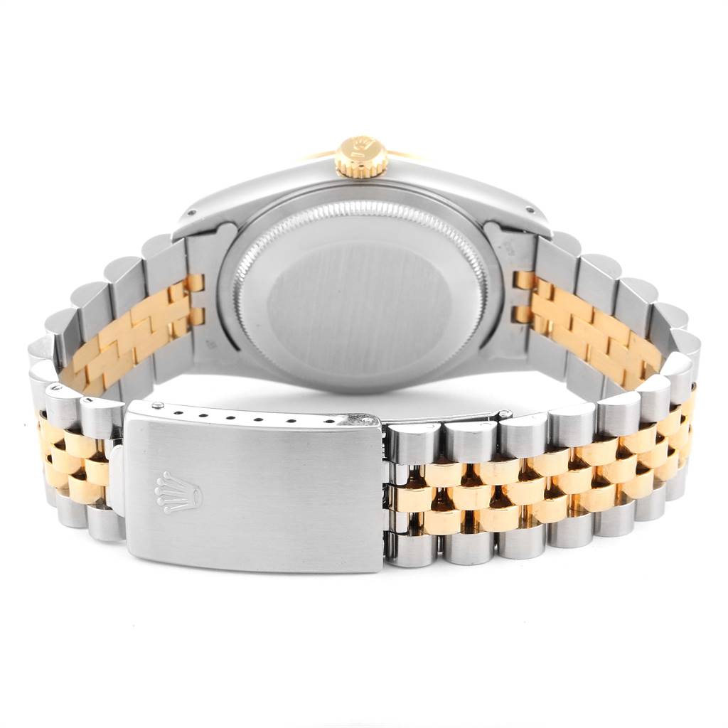 This image shows the back case, crown, and two-tone bracelet of a Rolex Datejust 16233 Men
s Steel and Gold (two tone) Beige Dial 16233 Men
s Steel and Gold (two tone) Beige Dial watch.