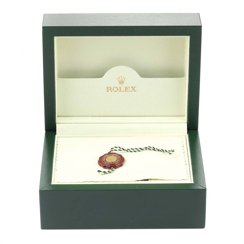 This image shows an open Rolex Datejust 116233 Men's Stainless Steel White Dial 116233 Men's Stainless Steel White Dial watch box with a green and white tag inside.