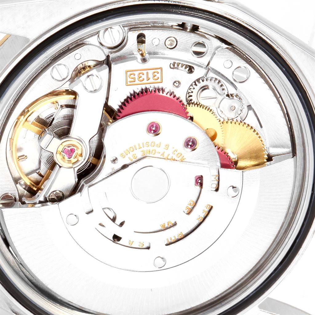 This image shows a close-up of the internal mechanism of a Rolex Datejust 16233 Men's Steel and Gold (two tone) Beige Dial 16233 Men's Steel and Gold (two tone) Beige Dial watch, highlighting the gears and intricate components.