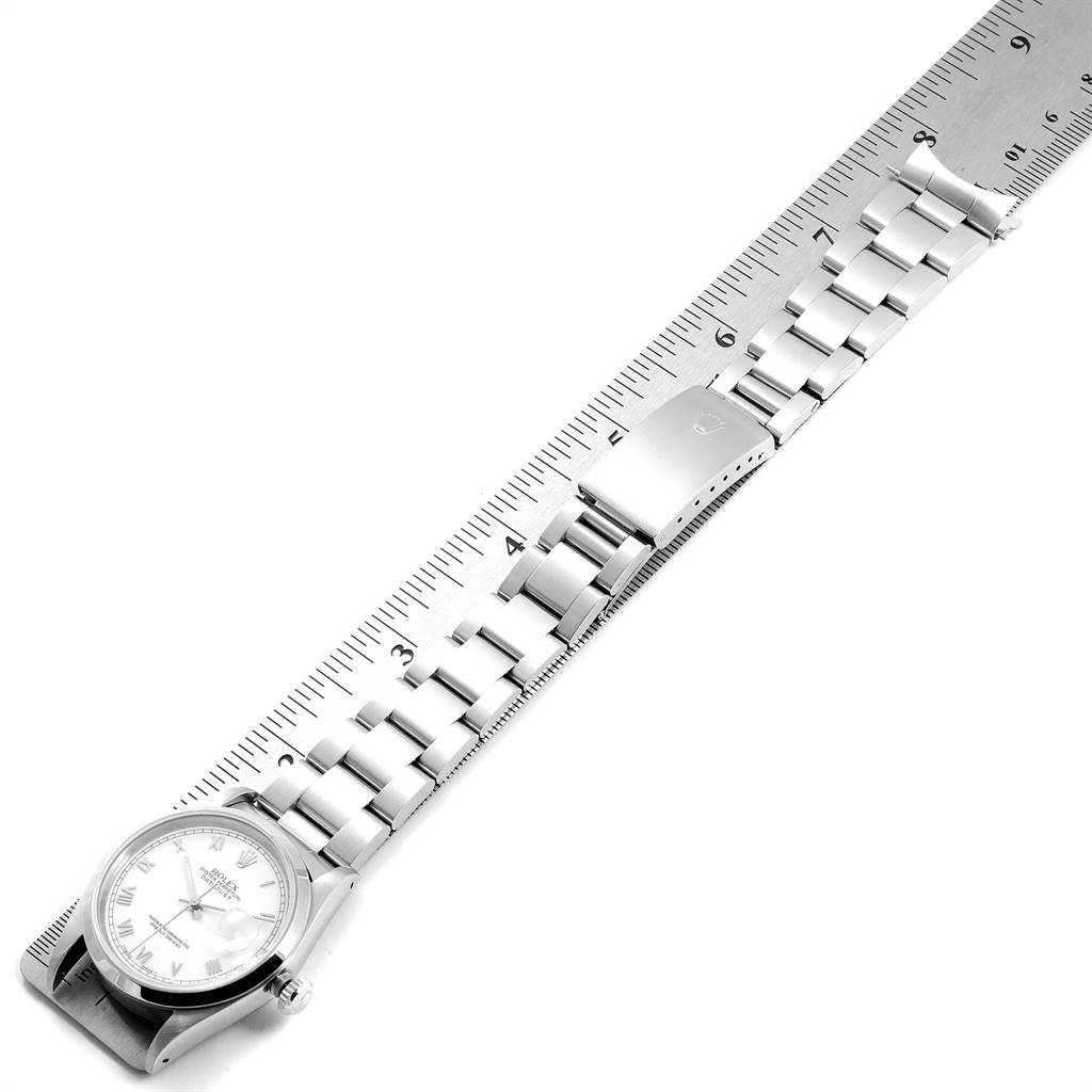 The image shows a Rolex Datejust 16200 Men's Stainless Steel White Dial 16200 Men's Stainless Steel White Dial watch with its full bracelet extended next to a ruler for measurement.