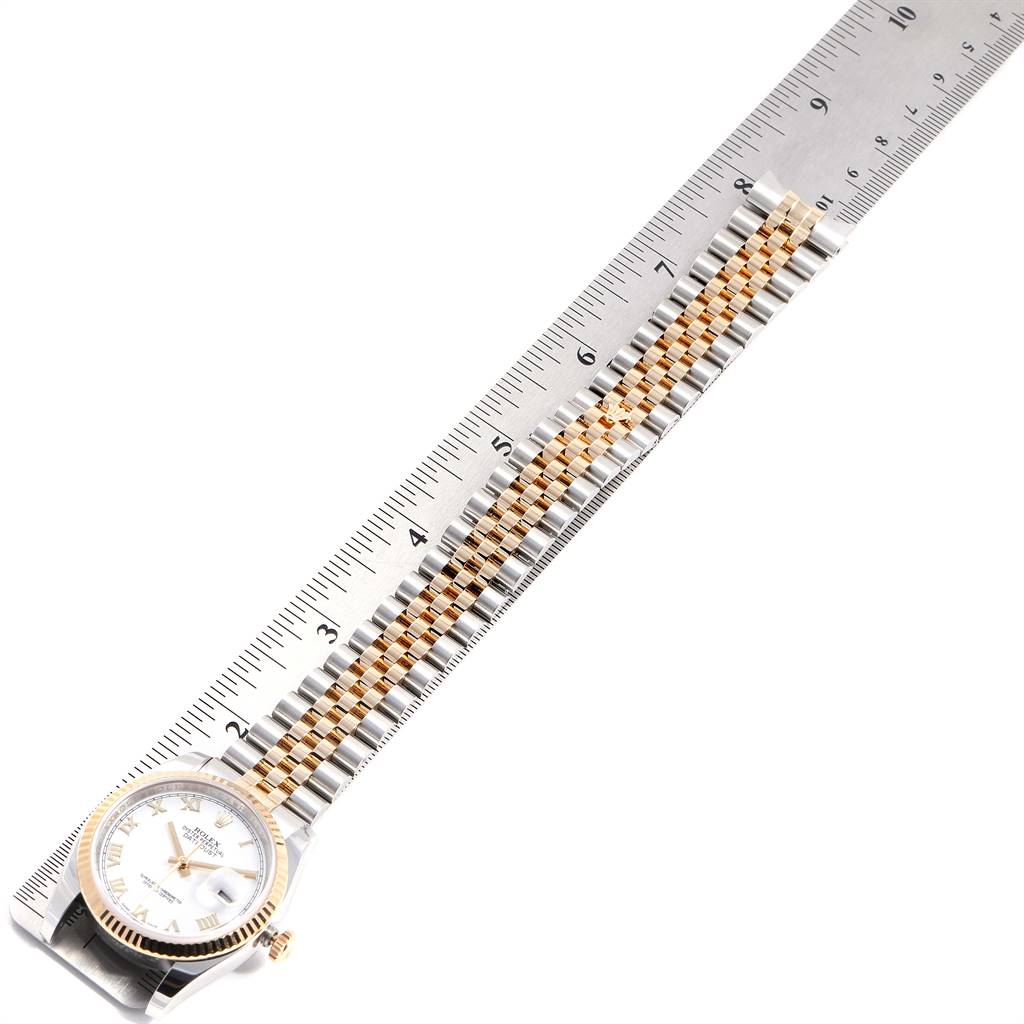 The image shows a Rolex Datejust 116233 Men's Stainless Steel White Dial 116233 Men's Stainless Steel White Dial watch placed next to a ruler, displaying the bracelet and part of the watch face.
