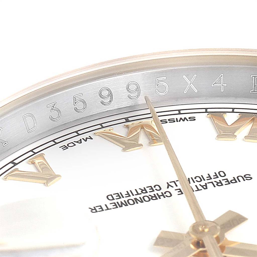 This close-up image of a Rolex Datejust 116233 Men's Stainless Steel White Dial 116233 Men's Stainless Steel White Dial watch focuses on the dial, Roman numerals, and partially visible rehaut with engravings.