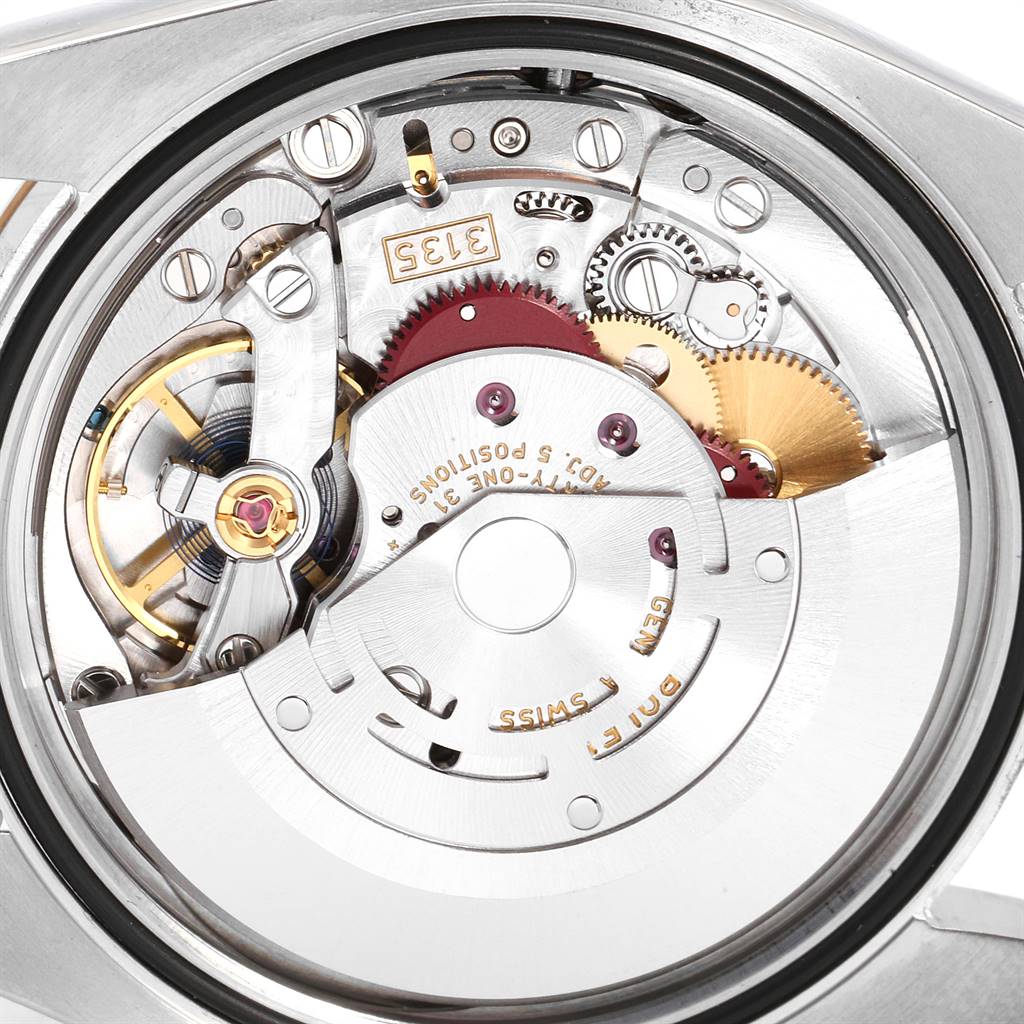 This is a close-up view of the Rolex Datejust 116233 Men's Stainless Steel White Dial 116233 Men's Stainless Steel White Dial's movement, showcasing its mechanical components and intricate gears.