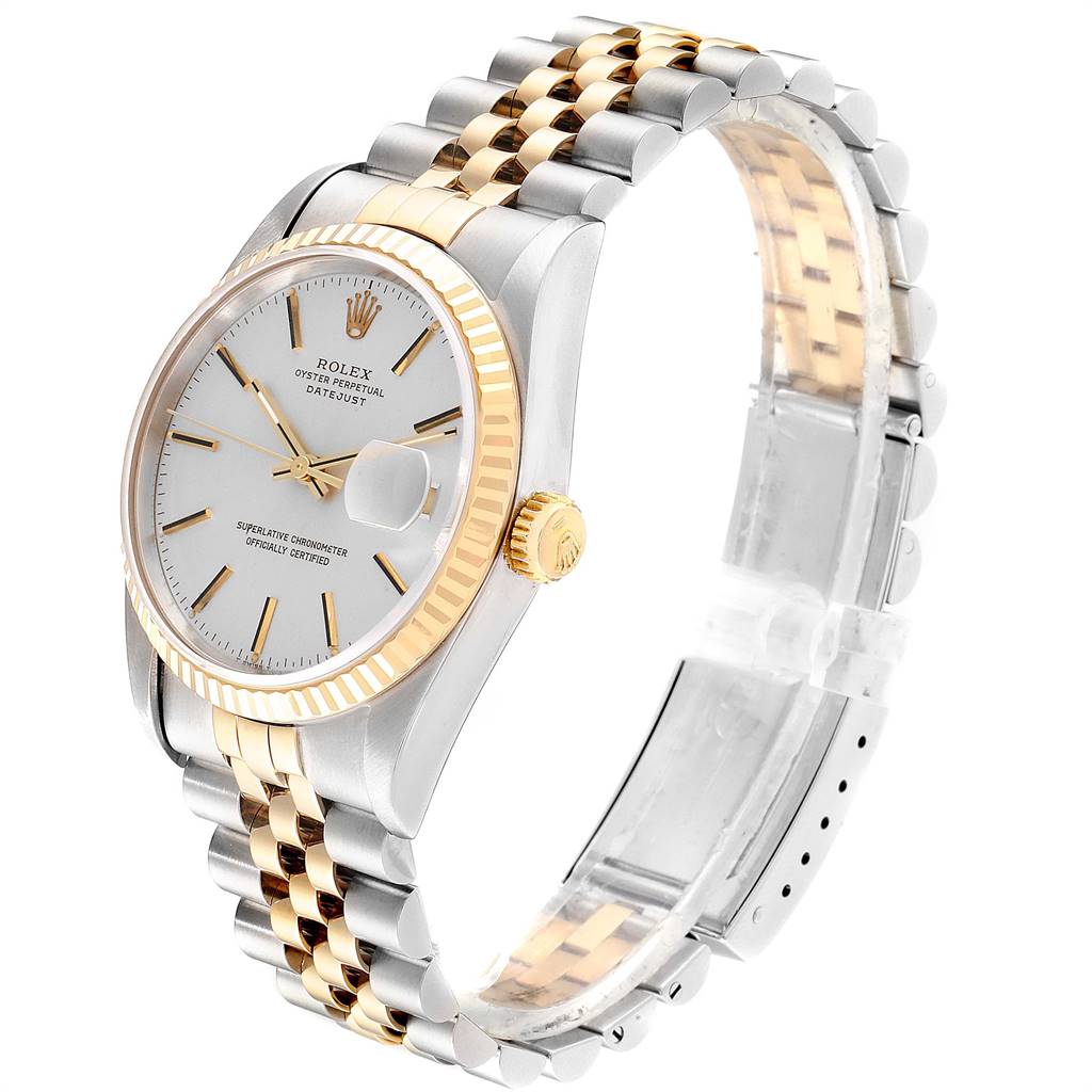 The image shows a Rolex Datejust 16233 Men
s Steel and Gold (two tone) Silver Dial 16233 Men
s Steel and Gold (two tone) Silver Dial watch from an angled side view, featuring a two-tone band, fluted bezel, and a cyclops date window.