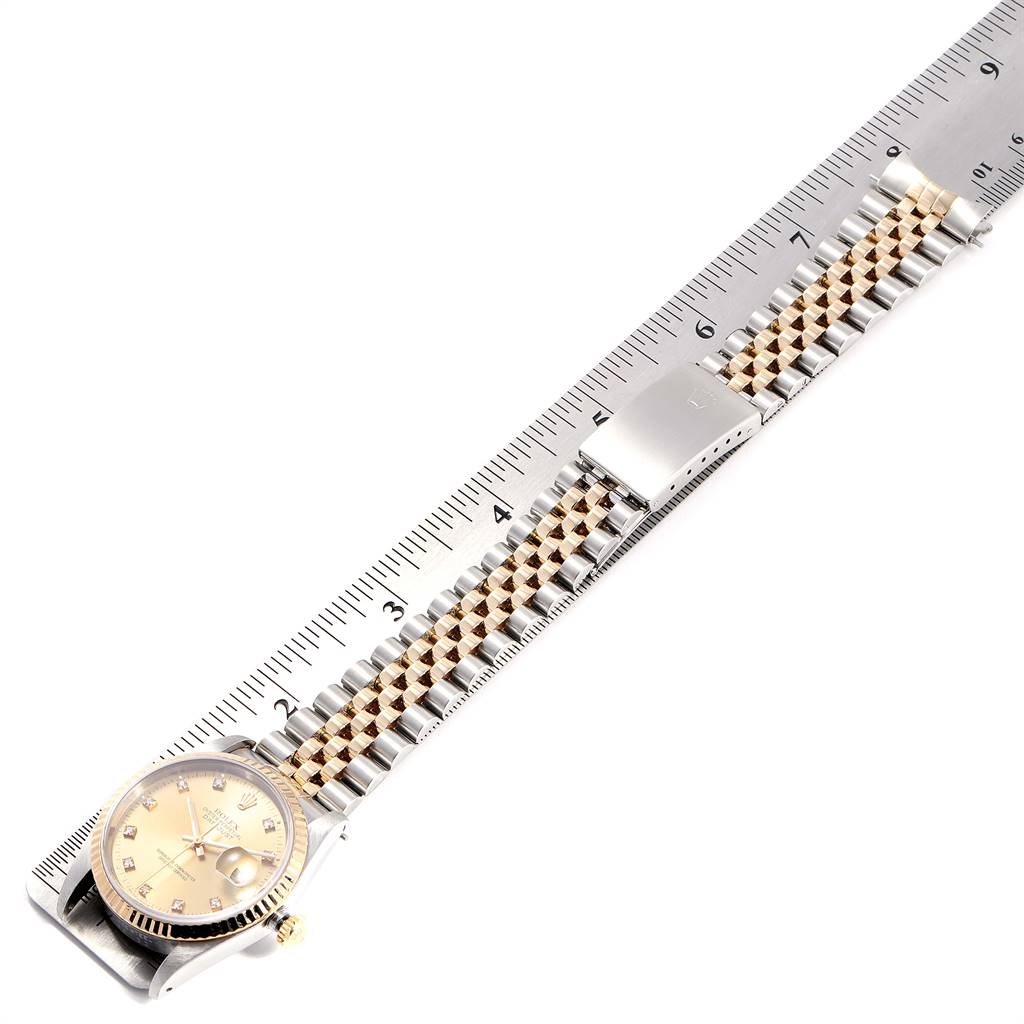 The image shows a Rolex Datejust 16233 Men's Steel and Gold (two tone) Champagne Dial 16233 Men's Steel and Gold (two tone) Champagne Dial watch laid flat beside a ruler, displaying the dial, bezel, and bracelet.