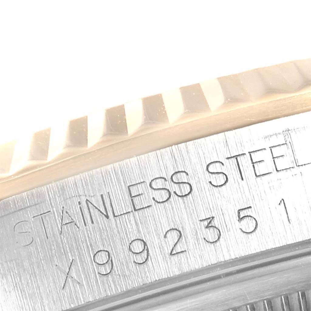 The image shows a close-up of the side and bezel of a Rolex Datejust 16233 Men
s Steel and Gold (two tone) Black Dial 16233 Men
s Steel and Gold (two tone) Black Dial watch, highlighting the "STAINLESS STEEL" engraving.