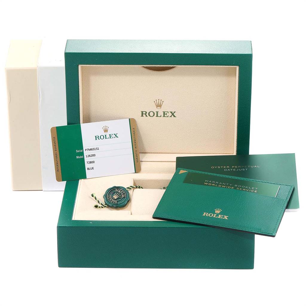 This image shows a Rolex Datejust 126200 Men's Stainless Steel Blue Dial 126200 Men's Stainless Steel Blue Dial watch box, warranty card, tag, and booklet from a front angle.