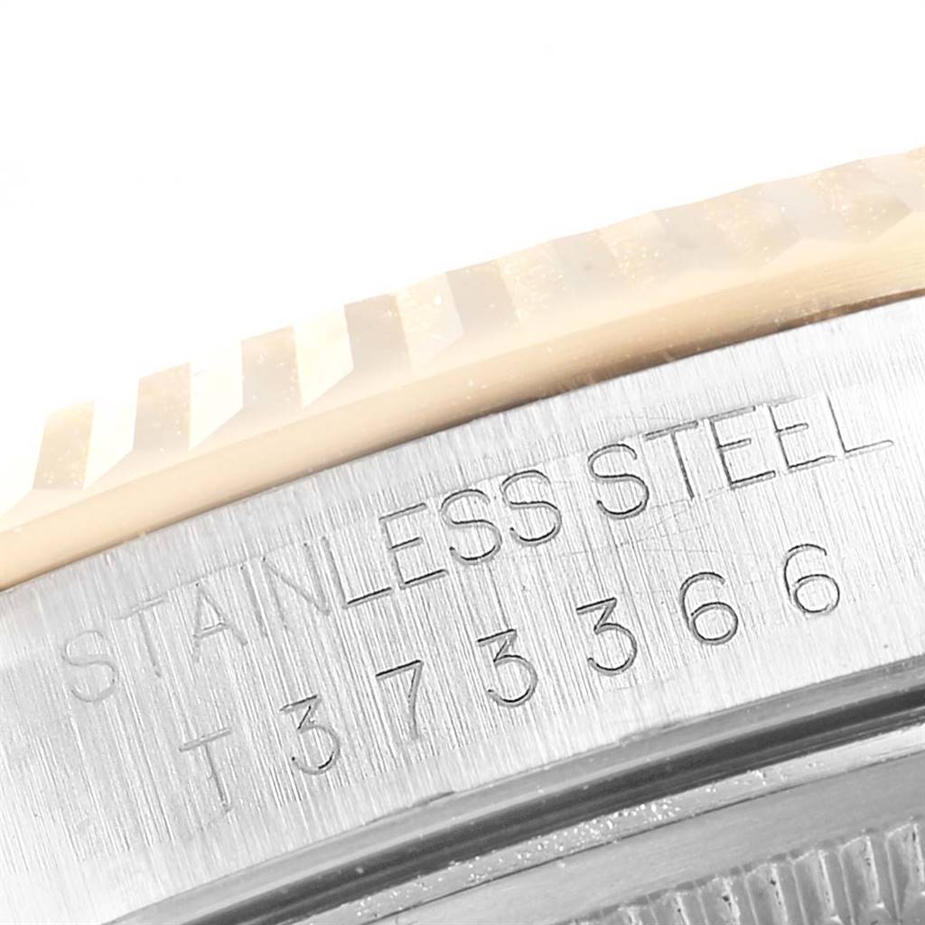 The image shows a close-up of the stainless steel bezel with engravings on a Rolex Datejust 16233 Men's Steel and Gold (two tone) Champagne Dial 16233 Men's Steel and Gold (two tone) Champagne Dial watch.