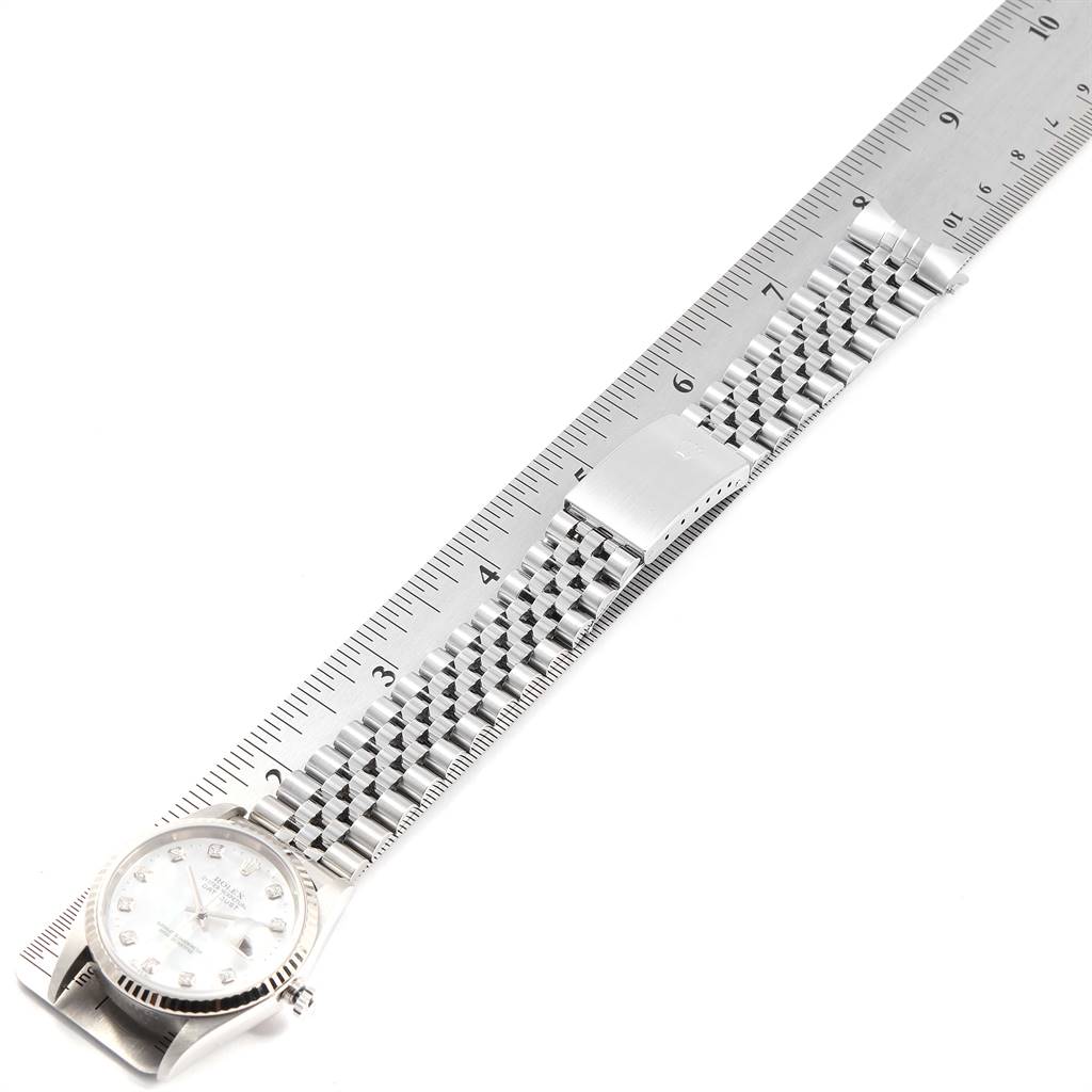 The image shows a Rolex Datejust 16234 Men's Stainless Steel Mother of Pearl Dial 16234 Men's Stainless Steel Mother of Pearl Dial watch at a top-down angle, highlighting the face, bracelet, and a ruler for scale.