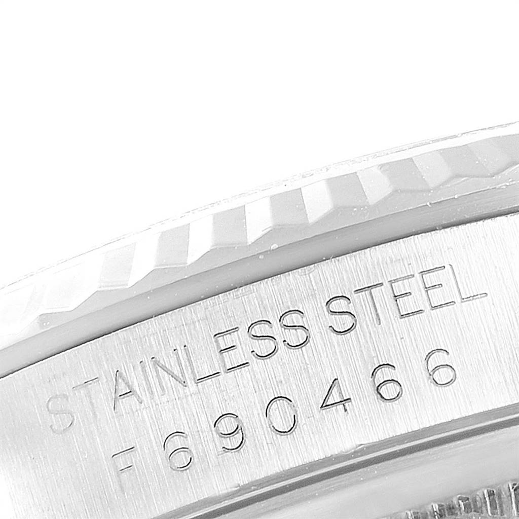 This image shows a close-up of the side of the stainless steel case of a Rolex Datejust 16234 Men's Stainless Steel Mother of Pearl Dial 16234 Men's Stainless Steel Mother of Pearl Dial watch with part of the bezel visible.