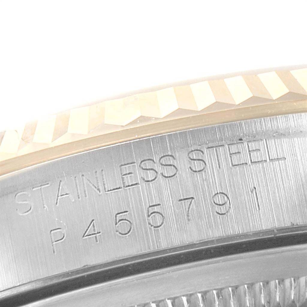 This image shows a close-up of the stainless steel casing and serial number on a Rolex Datejust 16233 Men
s Steel and Gold (two tone) Champagne Dial 16233 Men
s Steel and Gold (two tone) Champagne Dial watch.