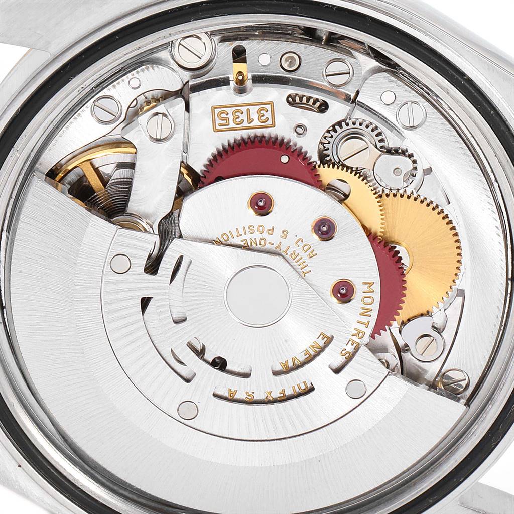 The image shows the internal mechanical movement of a Rolex Datejust 16233 Men
s Steel and Gold (two tone) Champagne Dial 16233 Men
s Steel and Gold (two tone) Champagne Dial watch from a close-up angle, highlighting various gears and components.