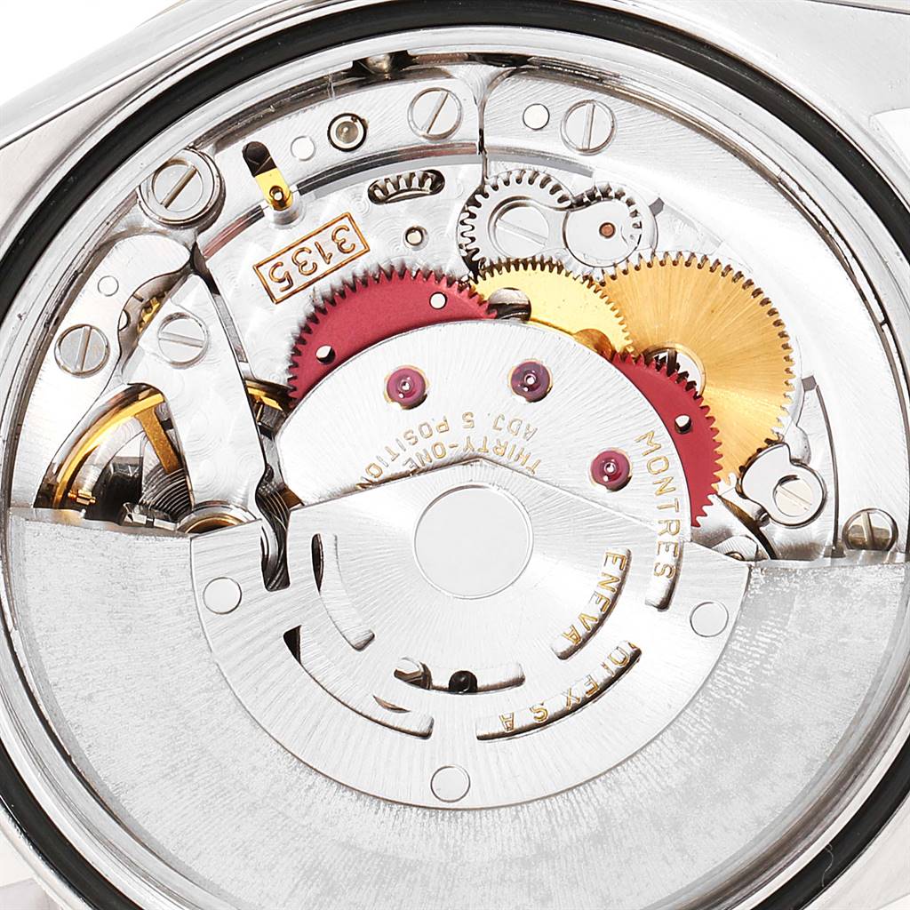 The image shows a close-up of the movement inside a Rolex Datejust 16233 Men
s Steel and Gold (two tone) Champagne Dial 16233 Men
s Steel and Gold (two tone) Champagne Dial watch, highlighting gears and intricate components.