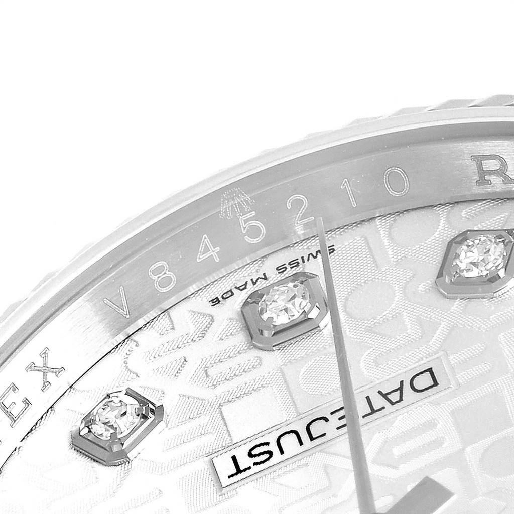 This close-up image of the Rolex Datejust 116234 Men's Stainless Steel Silver Dial 116234 Men's Stainless Steel Silver Dial watch features its bezel with serial numbers, part of the dial, and diamond hour markers.