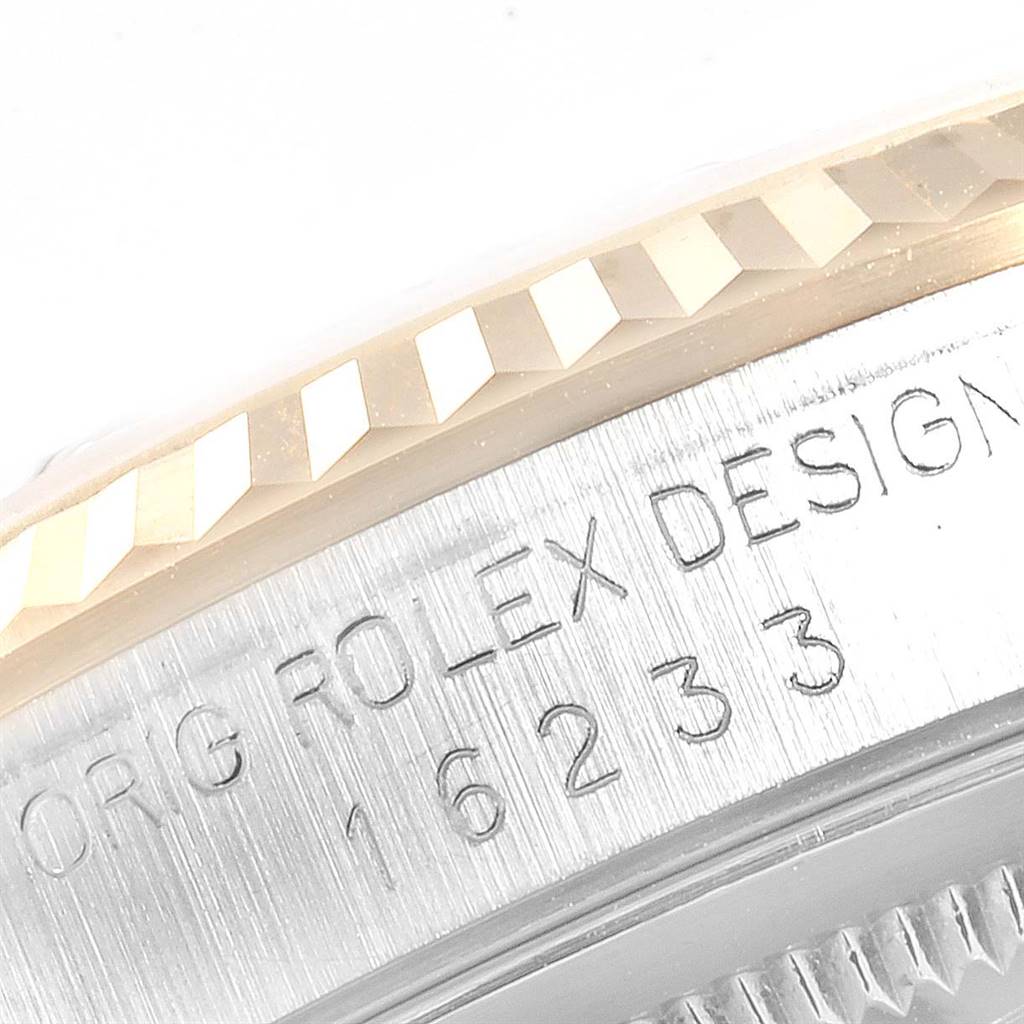 This image shows a close-up of the Rolex Datejust 16233 Men's Steel and Gold (two tone) Champagne Dial 16233 Men's Steel and Gold (two tone) Champagne Dial watch's fluted bezel and the engraved reference number on the case side.