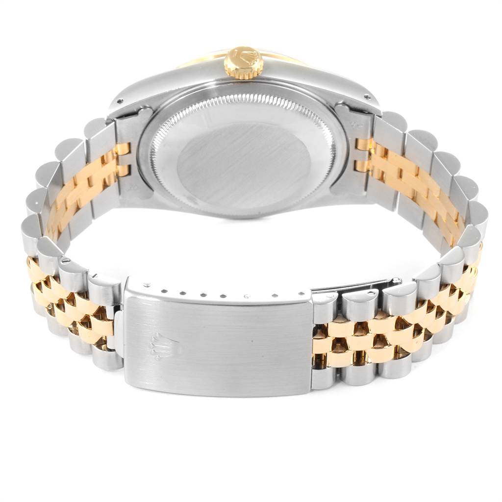 The image shows the back view of a Rolex Datejust 16233 Men's Steel and Gold (two tone) Champagne Dial 16233 Men's Steel and Gold (two tone) Champagne Dial, highlighting its case back, crown, and two-tone Jubilee bracelet with a clasp.